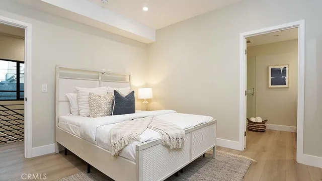 a bedroom with a bed and a night stand