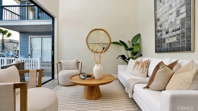 a living room with furniture a rug and a mirror