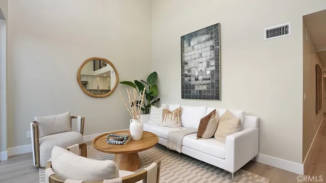 a living room with furniture a mirror and a window