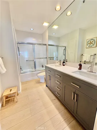 a bathroom with a painting on the wall and shower