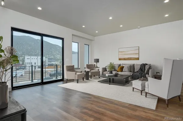 a living room with furniture and large windows