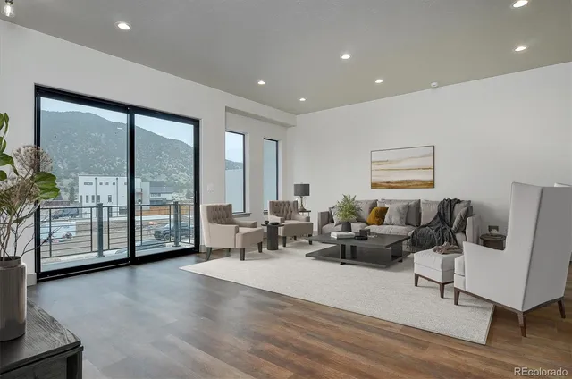 a living room with furniture and large windows
