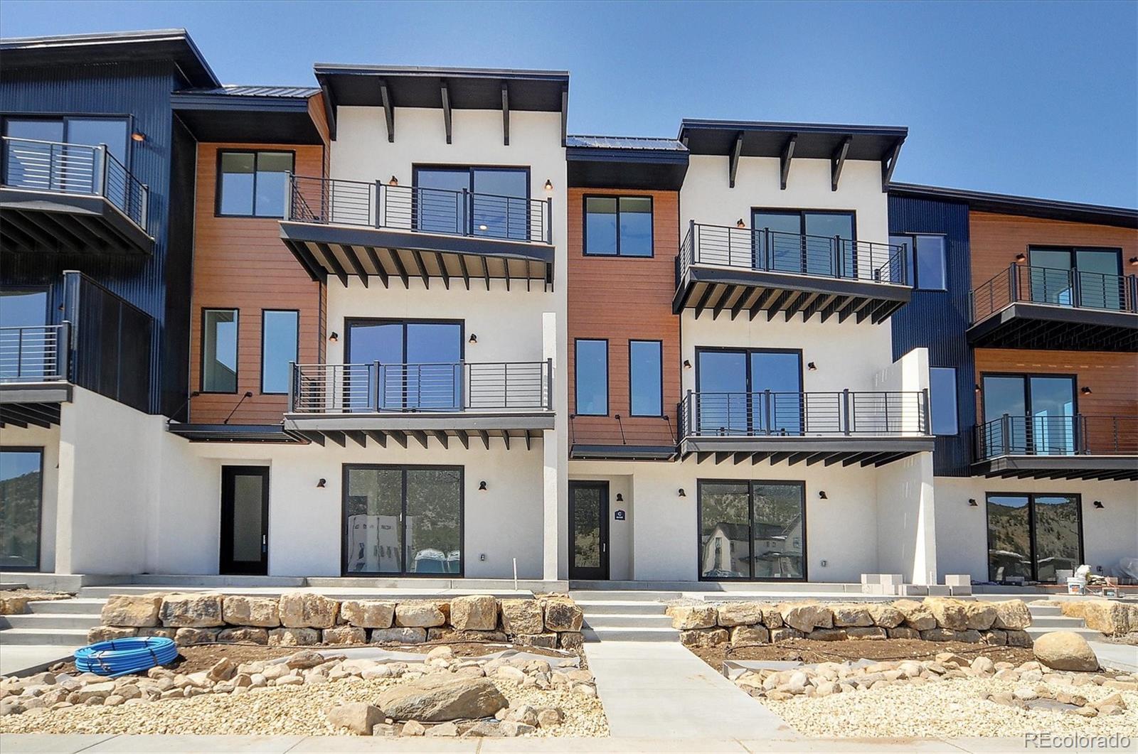 6398 Cleora Road, Unit F Salida, CO 81201 - Photo 31 of 34 a front view of a building with a yard and barbeque oven