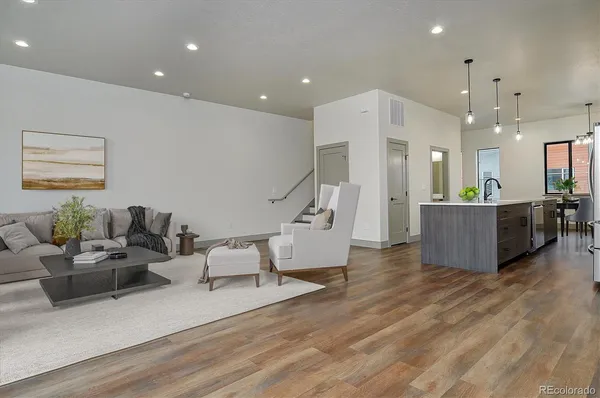 a living room with furniture and kitchen view