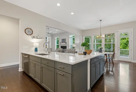 a living room with furniture and ceiling fan