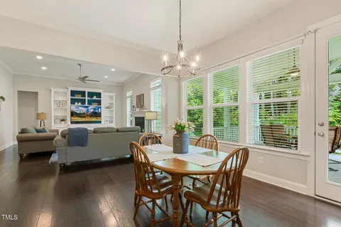 a view of a livingroom with wooden floor and staircase