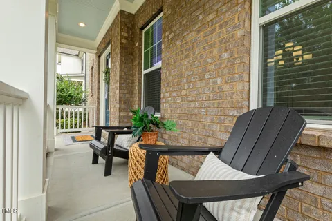 a view of a hallway and a dining room with furniture