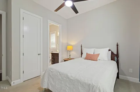 a en suite bathroom with a double vanity sink and a mirror