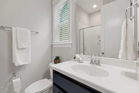 a bathroom with a toilet a sink and a window