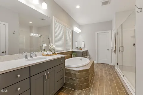 a view of a big room with windows and chandelier fan