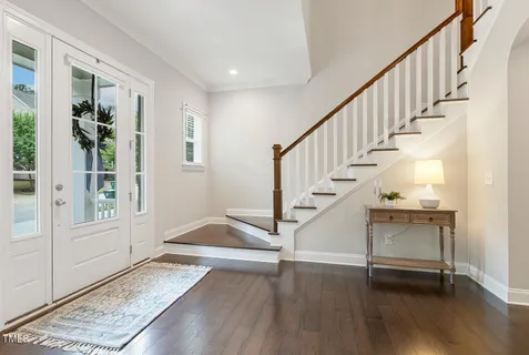 a kitchen with stainless steel appliances granite countertop a sink a stove and a refrigerator