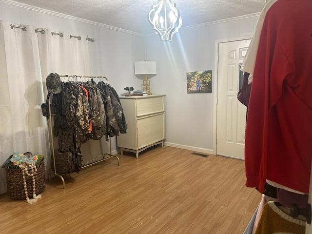 440 Angotti Road Crump, TN 38327 - Photo 12 of 30 Miscellaneous room featuring a notable chandelier, light hardwood / wood-style flooring, and crown molding