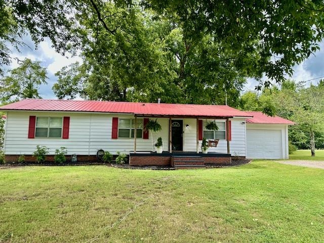 440 Angotti Road Crump, TN 38327 - Photo 27 of 30 Ranch-style house featuring covered porch, a garage, and a front lawn