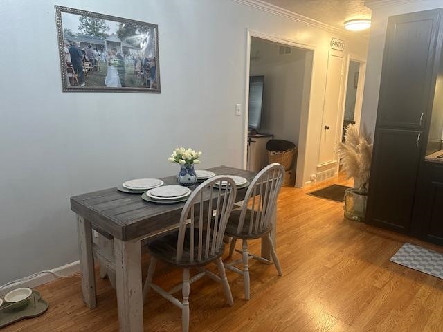 440 Angotti Road Crump, TN 38327 - Photo 7 of 30 Dining room featuring light wood-type flooring and ornamental molding
