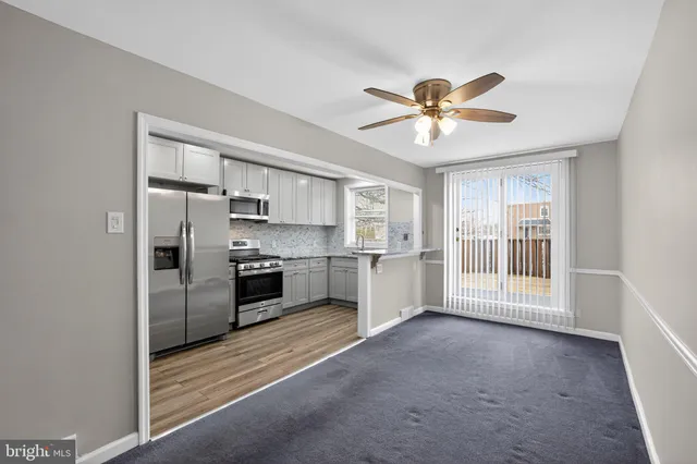 a kitchen with stainless steel appliances a stove a refrigerator and cabinets