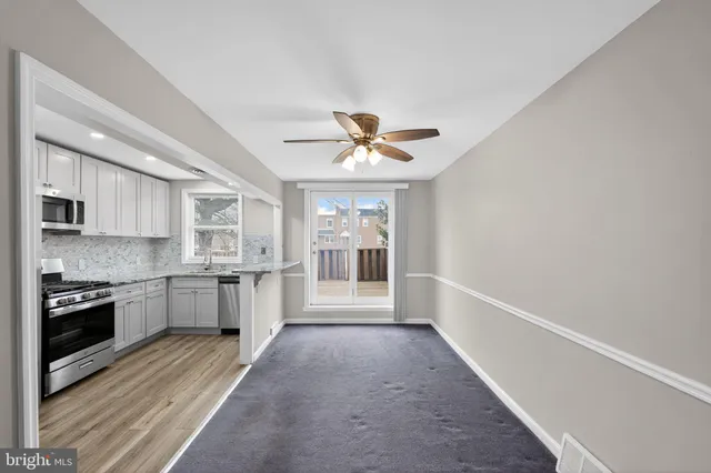 a view of a kitchen with a sink and a stove top oven