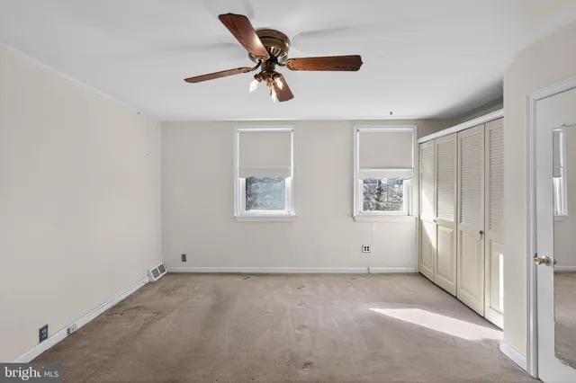 a view of a livingroom with a ceiling fan and window
