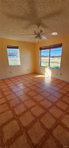 a view of empty room with window and wooden floor