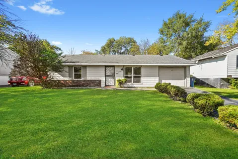 a front view of house with yard and green space