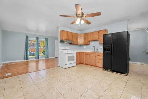 a kitchen with stainless steel appliances a refrigerator and microwave