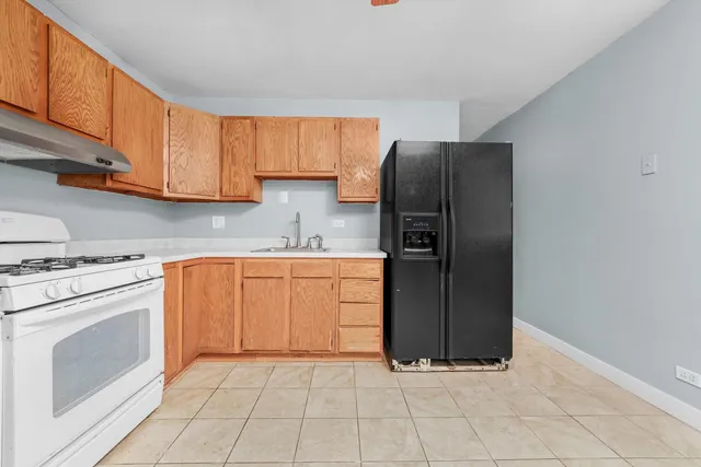 a kitchen with stainless steel appliances granite countertop a refrigerator sink and cabinets