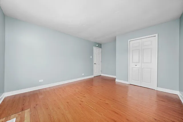 a view of an empty room and wooden floor