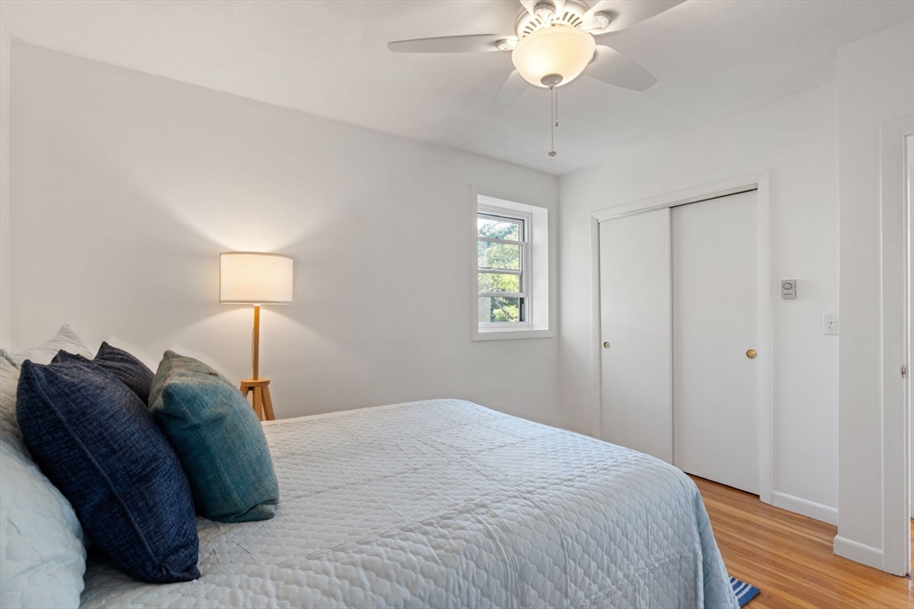 22 Branchfield Street, Unit D1 Boston, MA 02124 - Photo 13 of 20 a bedroom with a bed and a chandelier