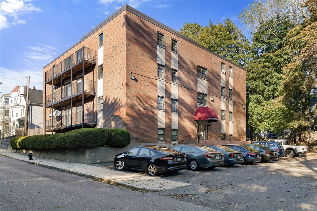 22 Branchfield Street, Unit D1 Boston, MA 02124 - Photo 18 of 20 a car parked in front of a building