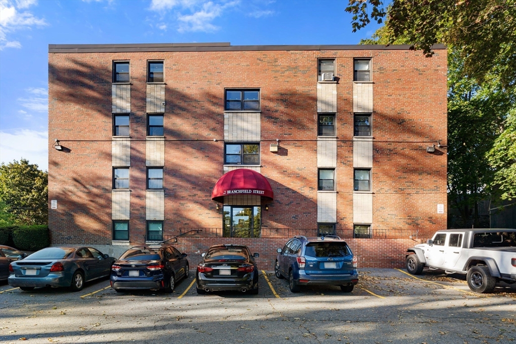 22 Branchfield Street, Unit D1 Boston, MA 02124 - Photo 19 of 20 a car parked in front of a building
