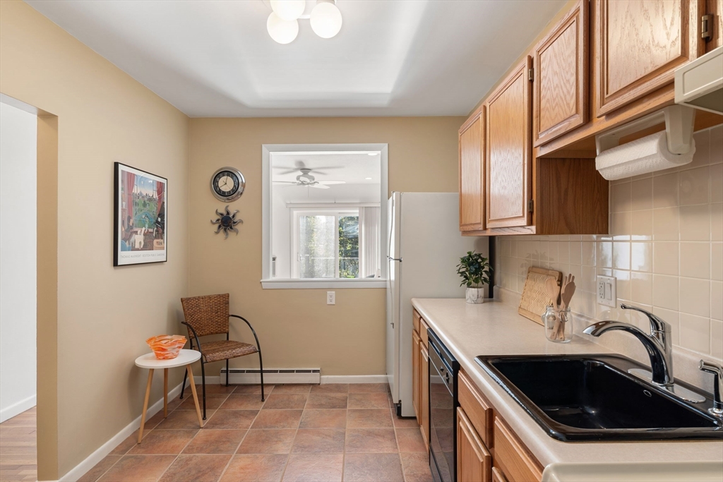 22 Branchfield Street, Unit D1 Boston, MA 02124 - Photo 7 of 20 a kitchen with a sink and a stove top oven