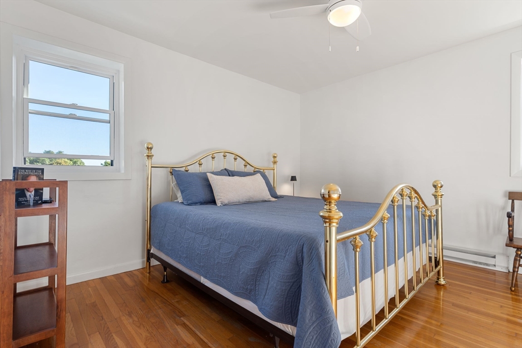 22 Branchfield Street, Unit D1 Boston, MA 02124 - Photo 10 of 20 a bedroom with two beds and wooden floor