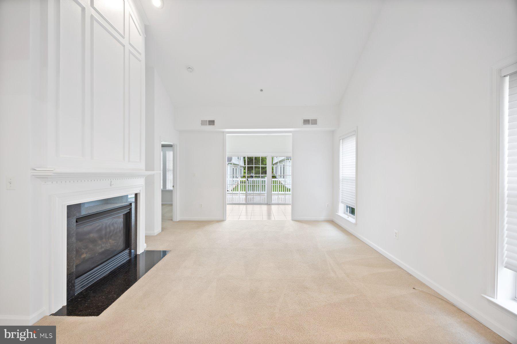 840 Horseshoe Lane, Unit 171 Taneytown, MD 21787 - Photo 13 of 37 a view of an empty room with a fireplace and a window