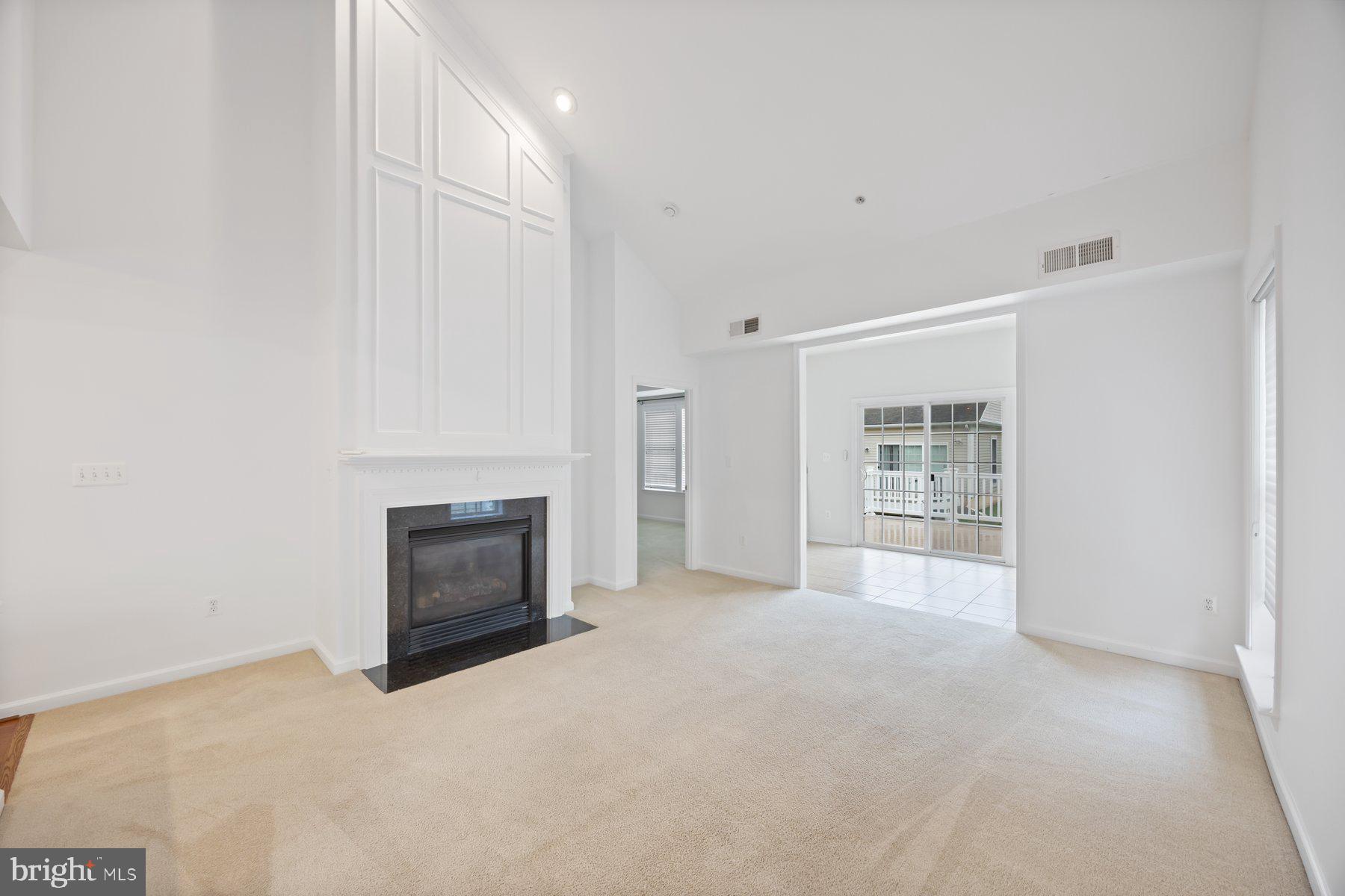 840 Horseshoe Lane, Unit 171 Taneytown, MD 21787 - Photo 14 of 37 a view of an empty room with a fireplace and a window