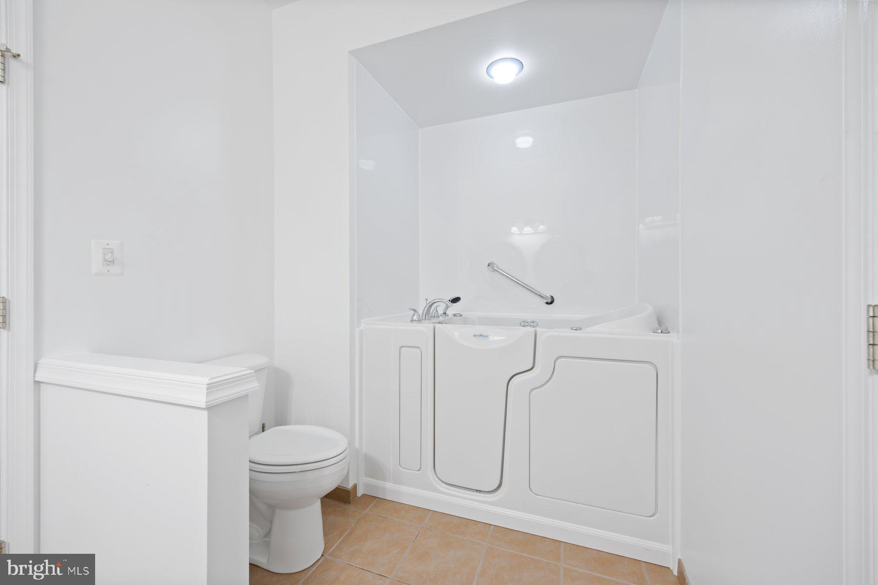 840 Horseshoe Lane, Unit 171 Taneytown, MD 21787 - Photo 21 of 37 a bathroom with a toilet and a shower