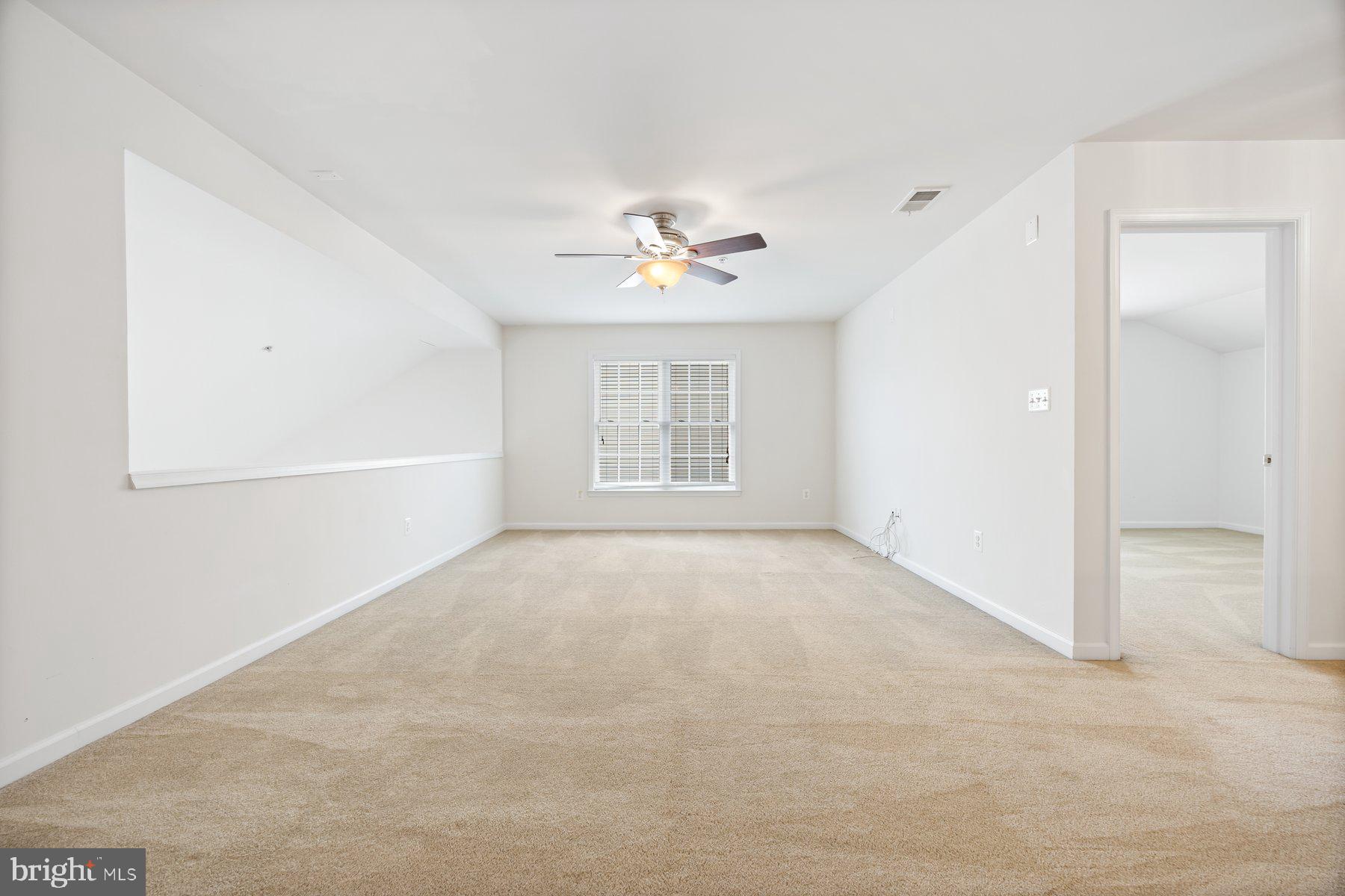 840 Horseshoe Lane, Unit 171 Taneytown, MD 21787 - Photo 27 of 37 an empty room with a window and a ceiling fan