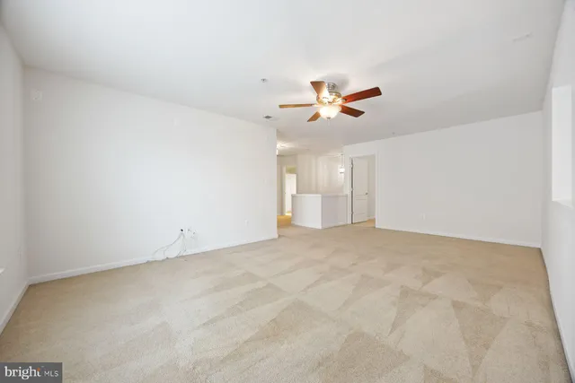 a view of empty room with ceiling fan