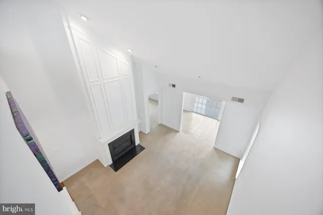 a view of a livingroom with wooden floor and staircase