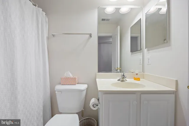 a bathroom with a sink toilet and a mirror