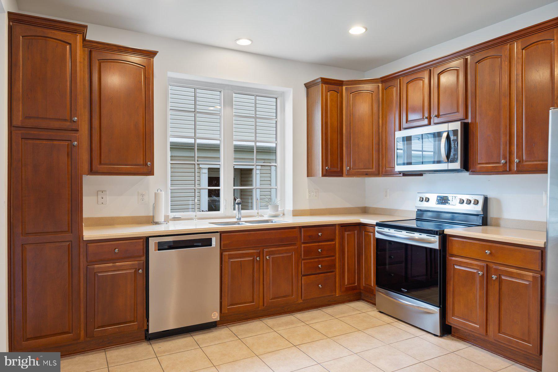 840 Horseshoe Lane, Unit 171 Taneytown, MD 21787 - Photo 6 of 37 a kitchen with stainless steel appliances granite countertop wooden cabinets a sink and dishwasher