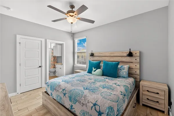 a bedroom with a bed and a chandelier