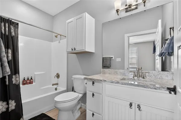 a bathroom with a sink toilet tub and shower