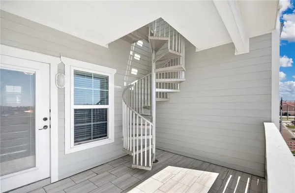 a view of entryway with wooden floor and a front door