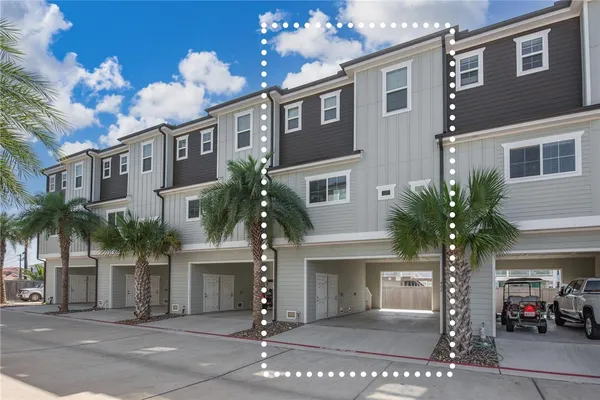 a front view of a house with a yard and palm trees
