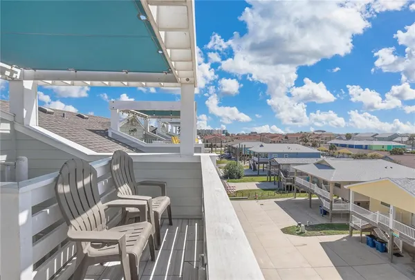 a view of a balcony with furniture
