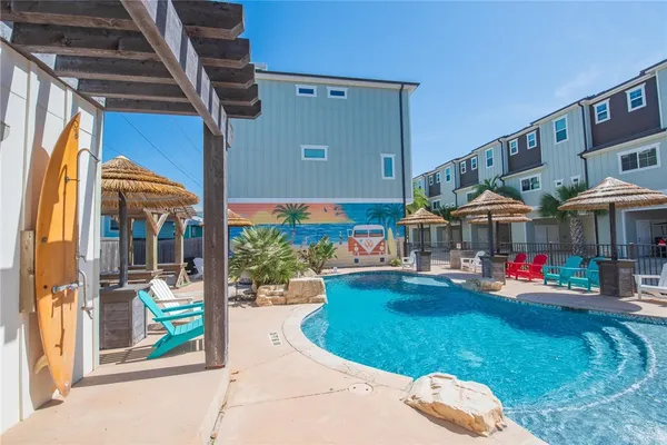 a view of swimming pool with outdoor seating