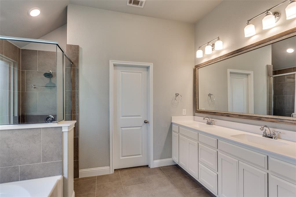 529 Inwood Street Benbrook, TX 76126 - Photo 14 of 28 a spacious bathroom with a shower sink and mirror
