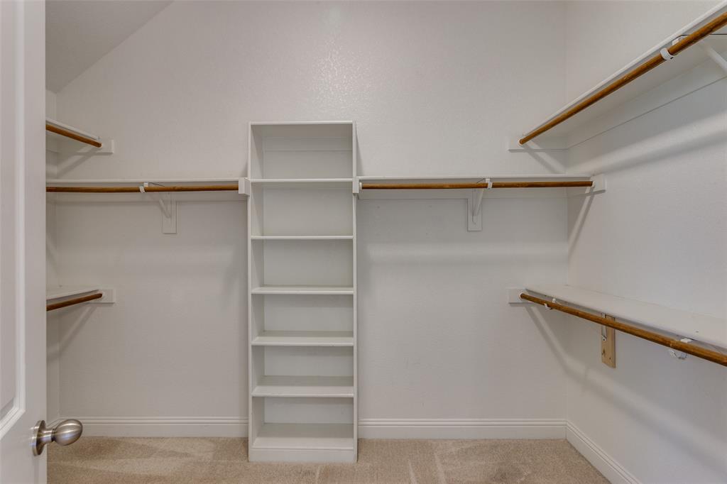 529 Inwood Street Benbrook, TX 76126 - Photo 17 of 29 a view of walk in closet with empty racks