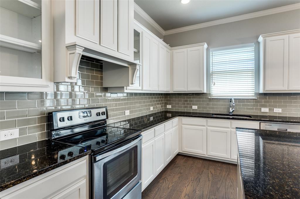 529 Inwood Street Benbrook, TX 76126 - Photo 7 of 29 a kitchen with stainless steel appliances granite countertop a sink a stove and cabinets