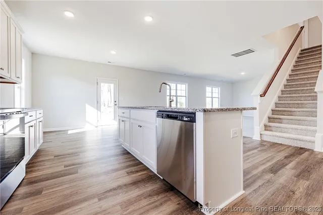 a view of kitchen with cabinets and wooden floor