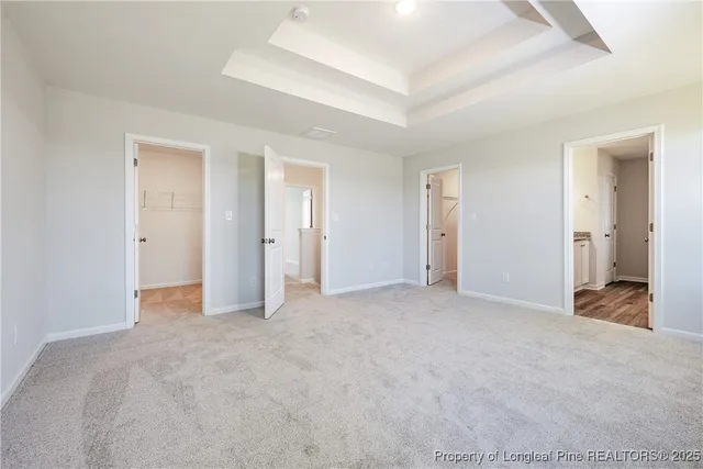 an empty room with a bathroom and a sink